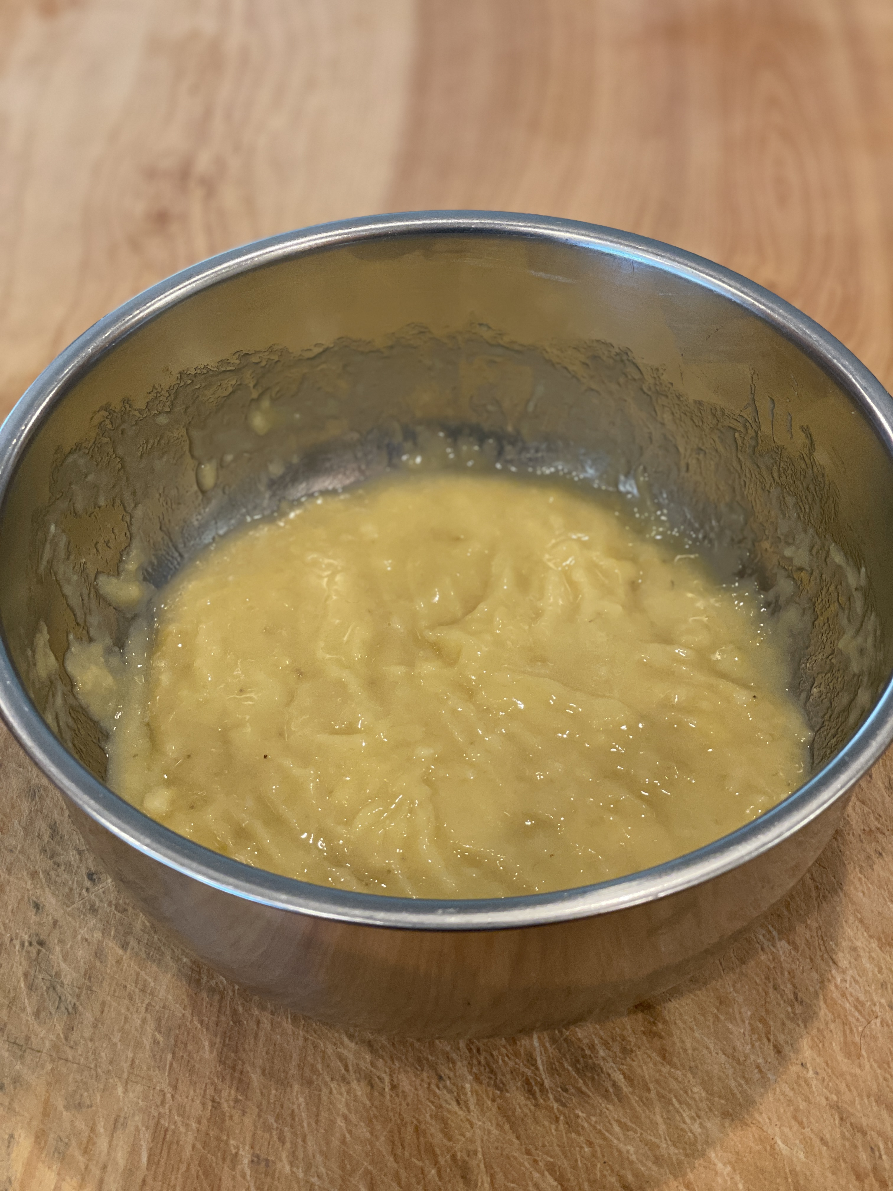 Mashed bananas in a mixing bowl
