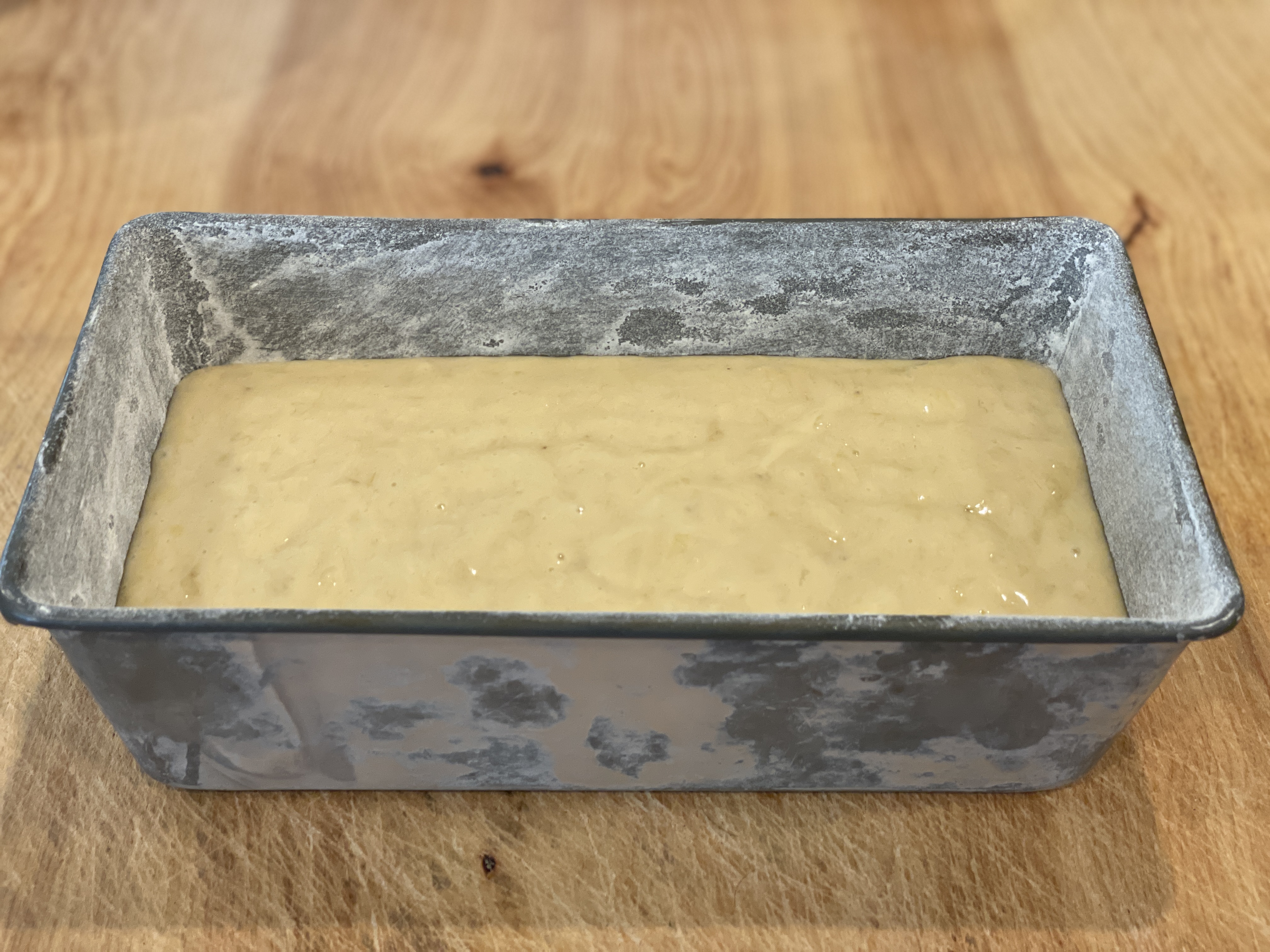 Banana bread batter poured into loaf pan